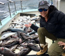 Linda with a boat full of Alaskan halibut, silver salmon and rock fish