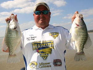 Captain Jacob Thompson helps show off a few of Lake Enid's big white crappie.